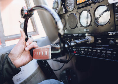 Hand on steering wheel of small plane